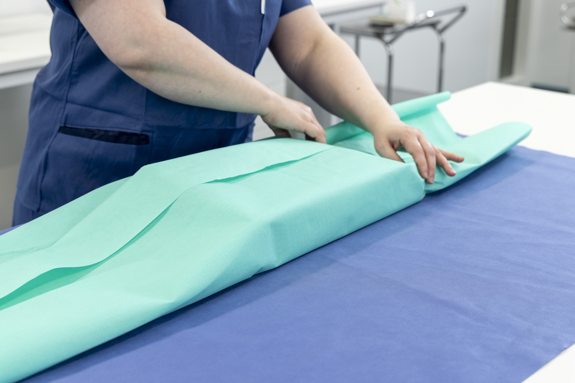 Packing medical devices in medical sterilization wrap.